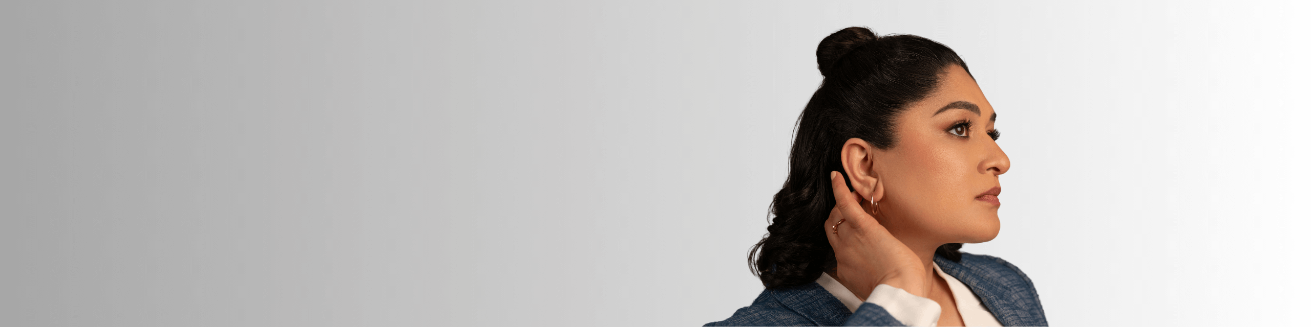 Woman with hand near ear