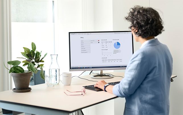 Dentist standing at the table working with 3Shape Lab Management Software